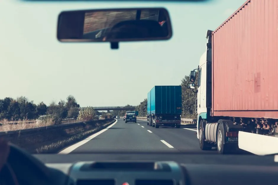 Blue and red freight truck driving on the road
