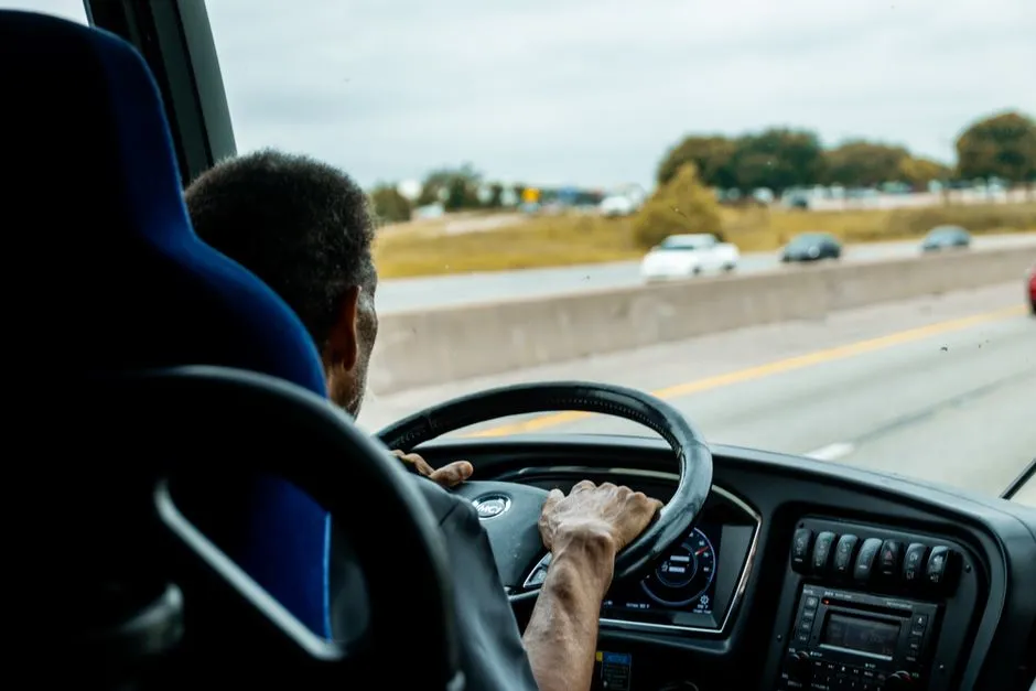 Bus driver navigating a busy highway