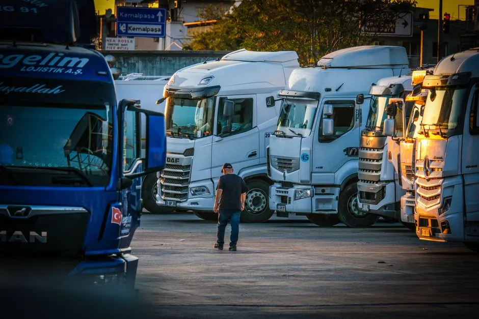 Semi-trucks parked in a lot at sunset
